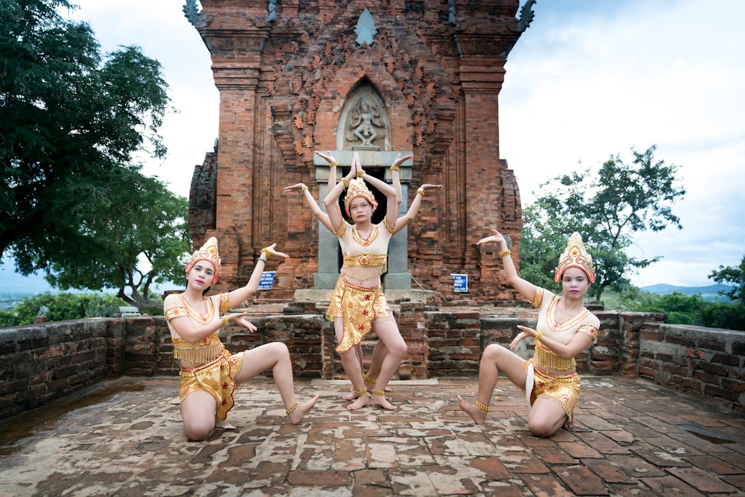 a group of young women dancing in front of a building