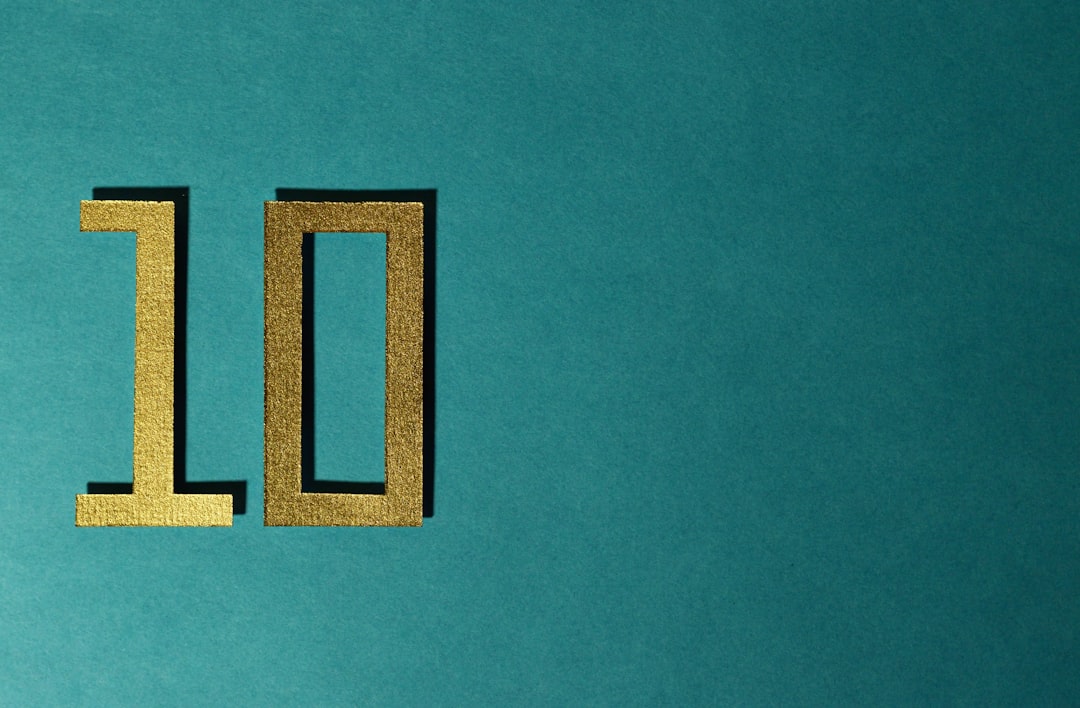 The number 10 is gold on a teal background.